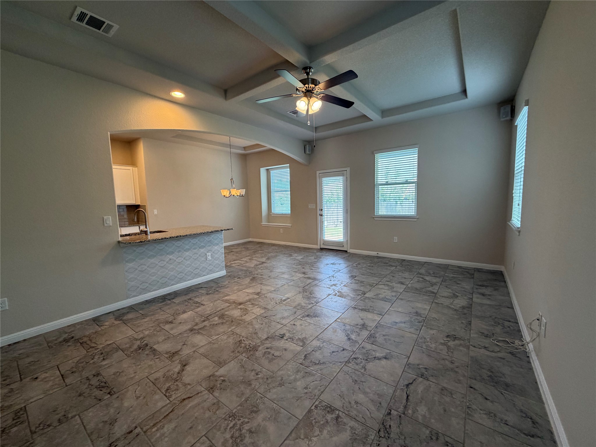419 Gettysburg Loop Elgin, TX 78621 - Photo 20 of 21 A contemporary open floorplan living area featuring elegant tray ceilings and durable tiled flooring.