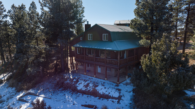 1505 West Elk Ridge Drive Alton, UT 84710 - Photo 7 of 53 Snow covered property with a metal roof, a chimney, a porch, and a gambrel roof