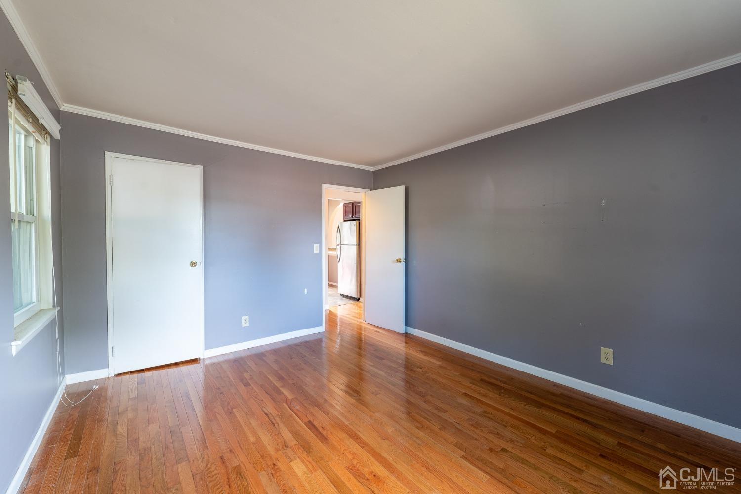 93 Fox Road, Unit 7A Edison, NJ 08817 - Photo 12 of 21 a view of an empty room with wooden floor