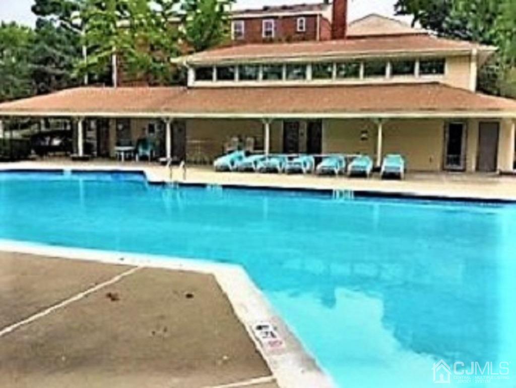 93 Fox Road, Unit 7A Edison, NJ 08817 - Photo 17 of 21 a front view of a house with swimming pool having outdoor seating