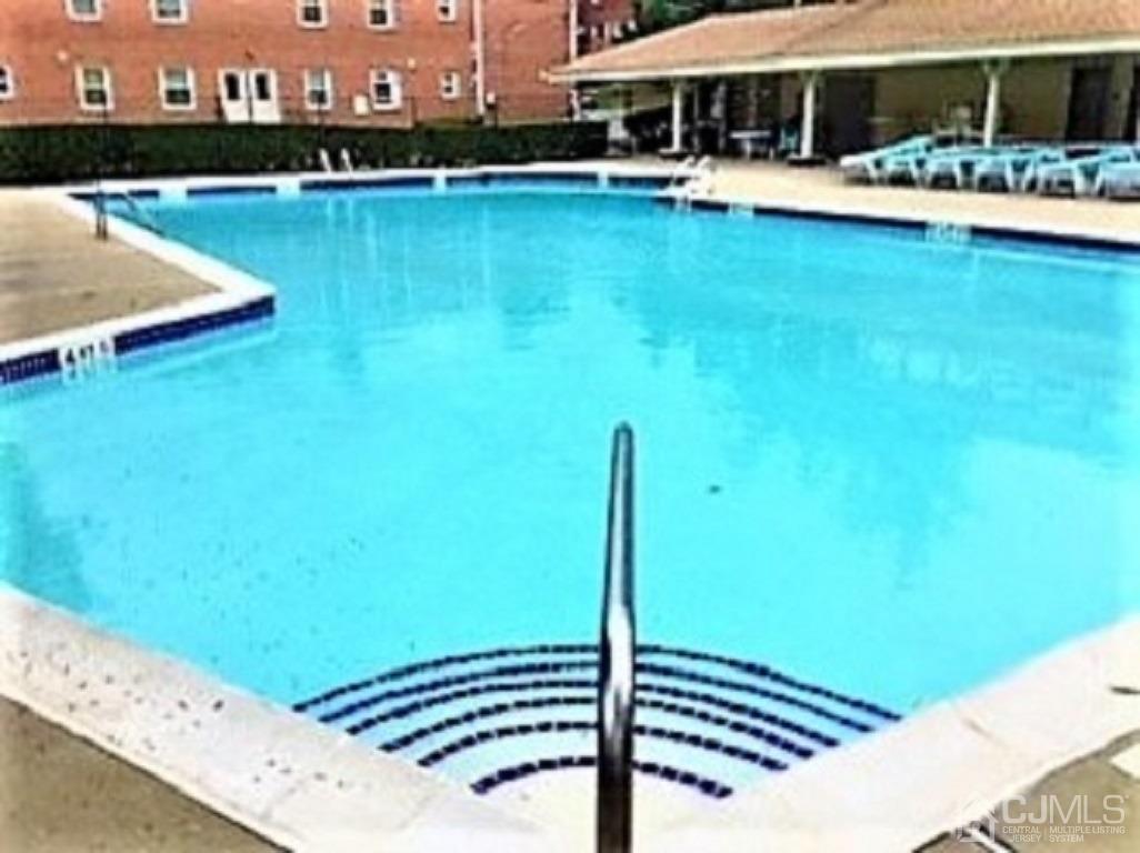 93 Fox Road, Unit 7A Edison, NJ 08817 - Photo 18 of 21 a view of a swimming pool with a lounge chair