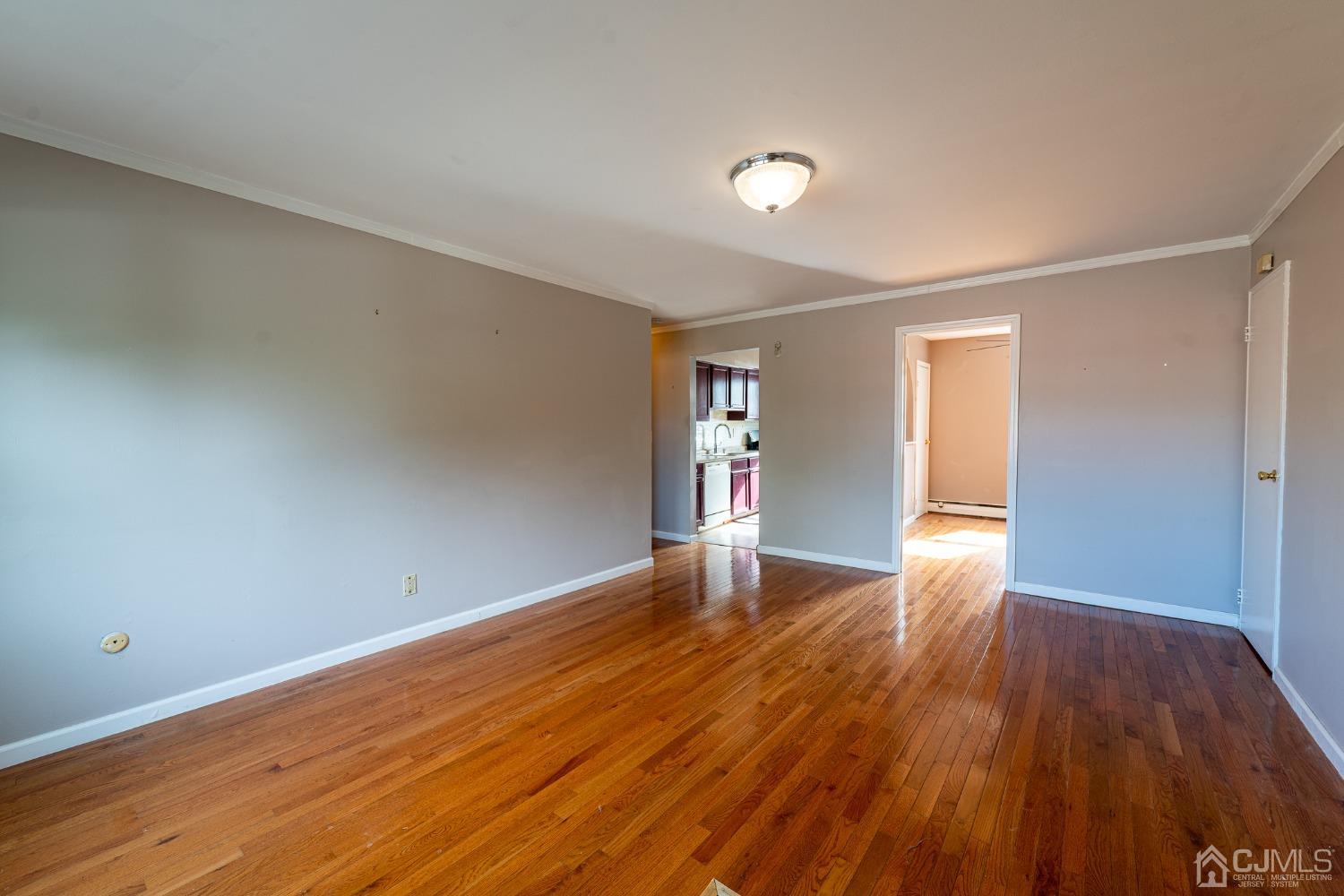 93 Fox Road, Unit 7A Edison, NJ 08817 - Photo 4 of 21 a view of empty room with wooden floor and fan