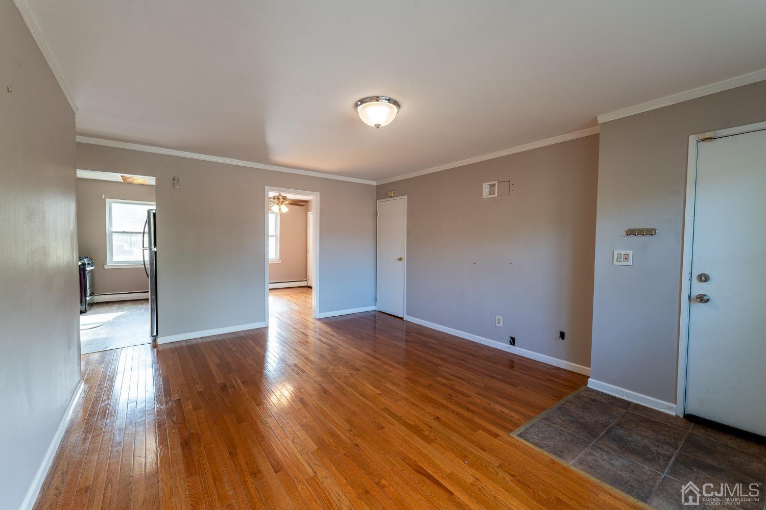 93 Fox Road, Unit 7A Edison, NJ 08817 - Photo 5 of 21 a view of an empty room with wooden floor and a window