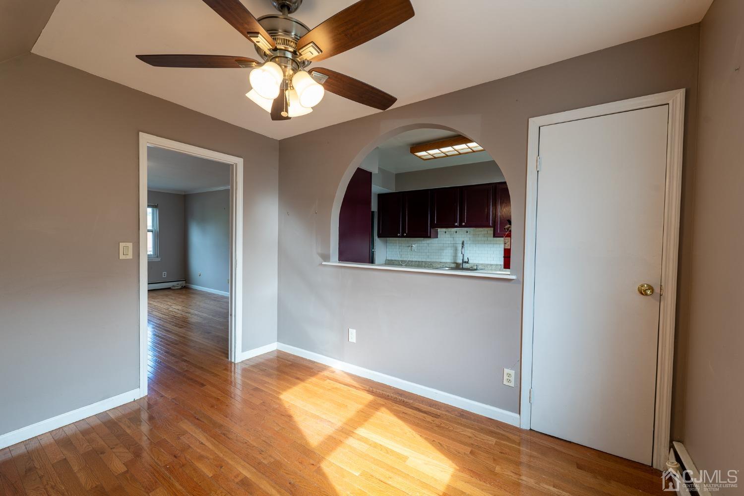 93 Fox Road, Unit 7A Edison, NJ 08817 - Photo 8 of 21 a view of a livingroom with wooden floor and a ceiling fan