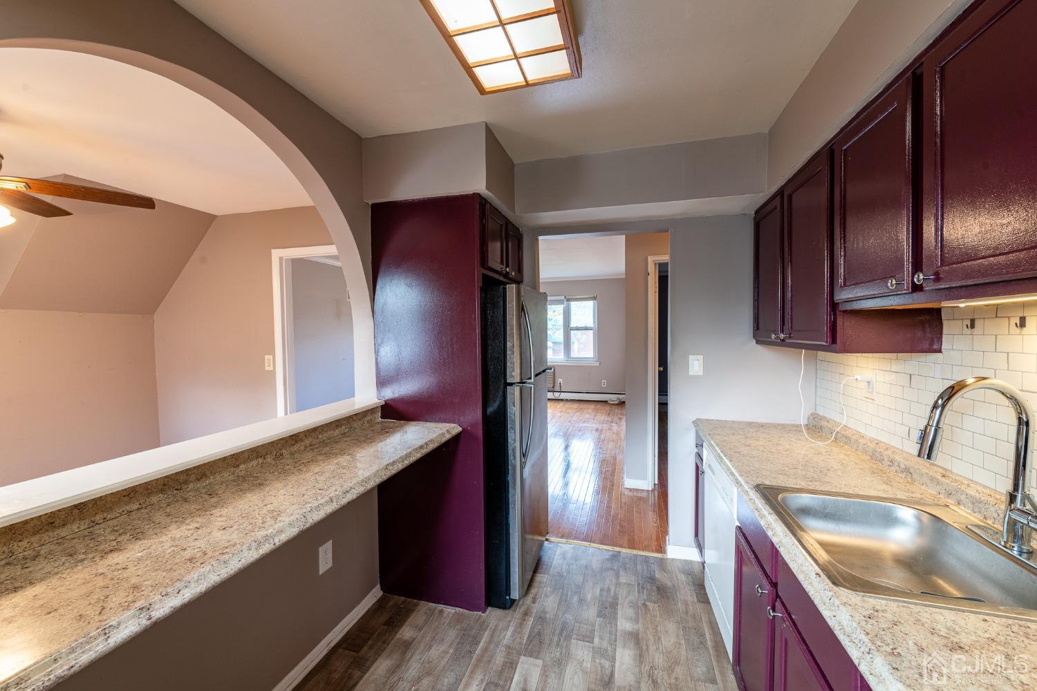 93 Fox Road, Unit 7A Edison, NJ 08817 - Photo 10 of 21 a kitchen with granite countertop wooden cabinets a sink and dishwasher