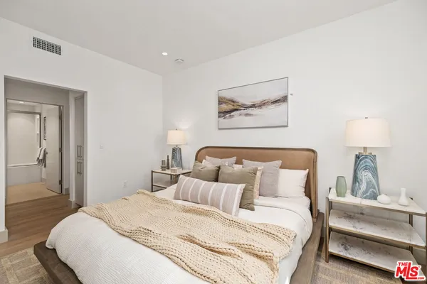 a bedroom with bed and cupboard