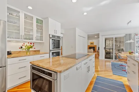 a kitchen with granite countertop a stove and a sink