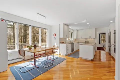a living room with kitchen island furniture and a large window