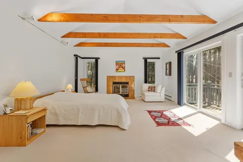 a bedroom with a bed and dresser with mirror