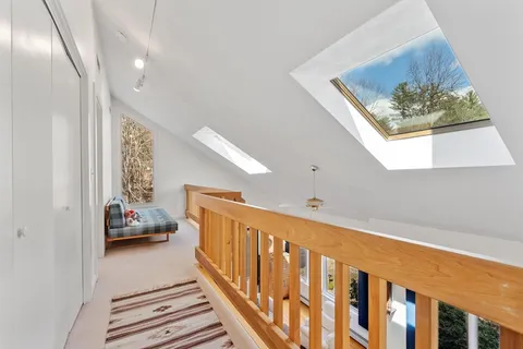 a bedroom with a large bed couch and a window