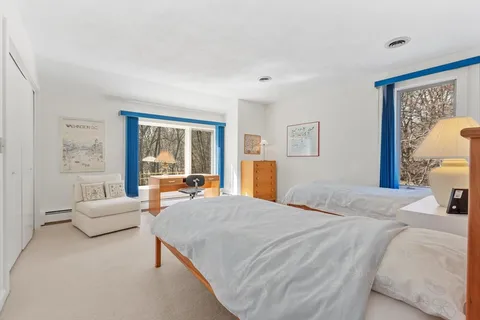 a bedroom with a bed and a chair