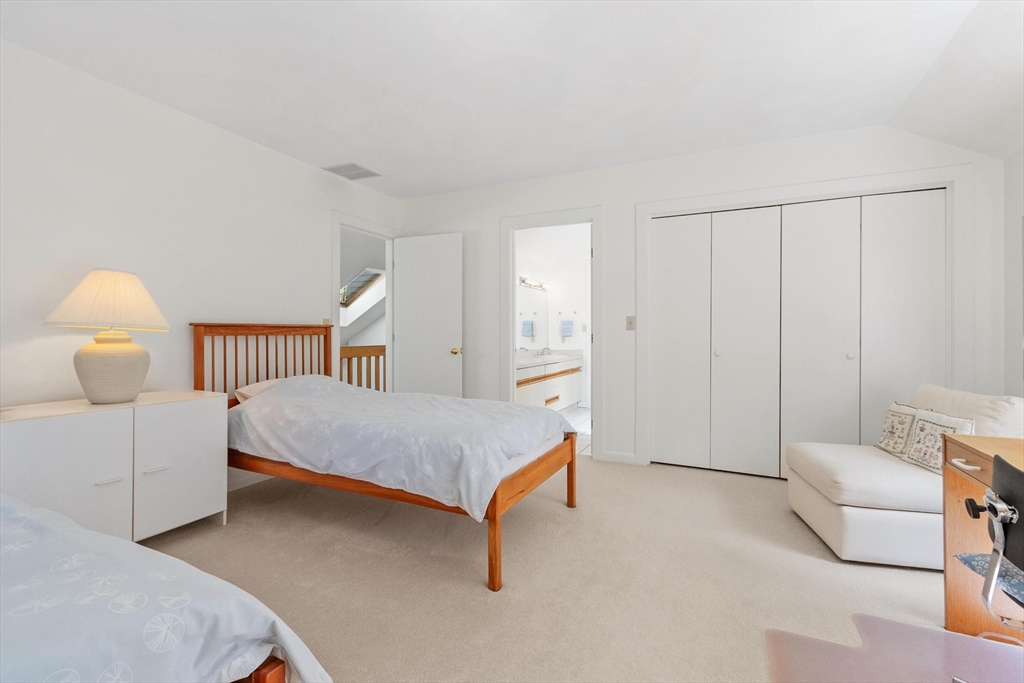781 Strawberry Hill Road Concord, MA 01742 - Photo 27 of 42 a bedroom with a bed and a chair
