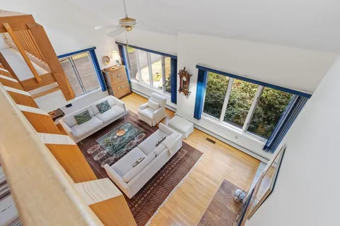 a view of a room with wooden floor and outdoor view