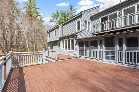 a view of a balcony with wooden floor and fence