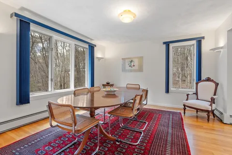 a dining room with furniture and wooden floor