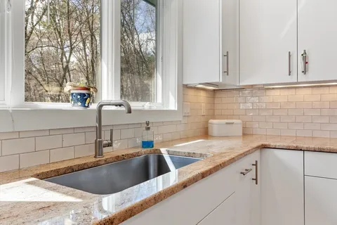 a kitchen with a sink and cabinets