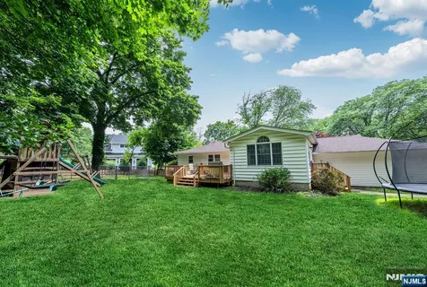 a view of a house with backyard and porch