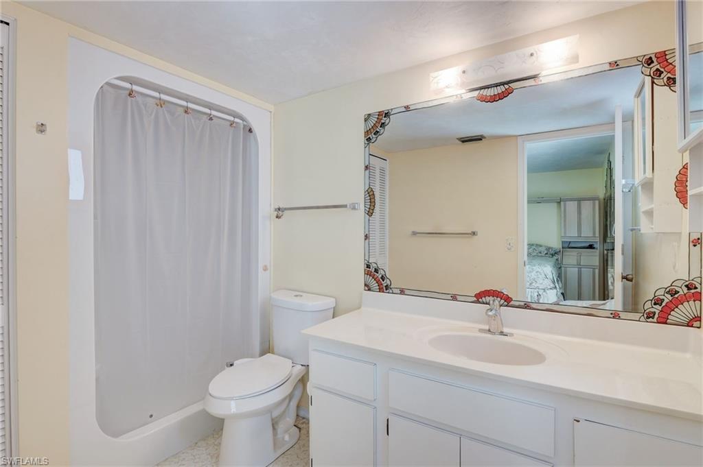 115 Georgetown Boulevard, Unit 115 Naples, FL 34112 - Photo 16 of 45 a bathroom with a sink toilet and shower