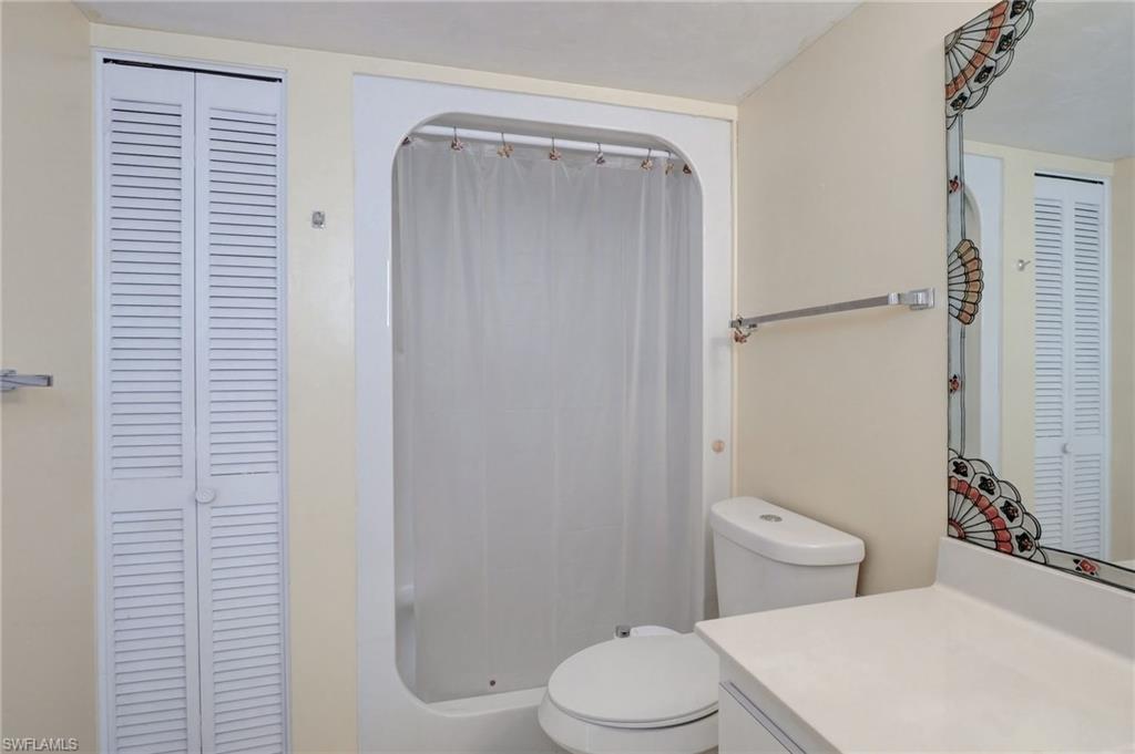 115 Georgetown Boulevard, Unit 115 Naples, FL 34112 - Photo 17 of 45 a white toilet sitting next to a bathroom sink