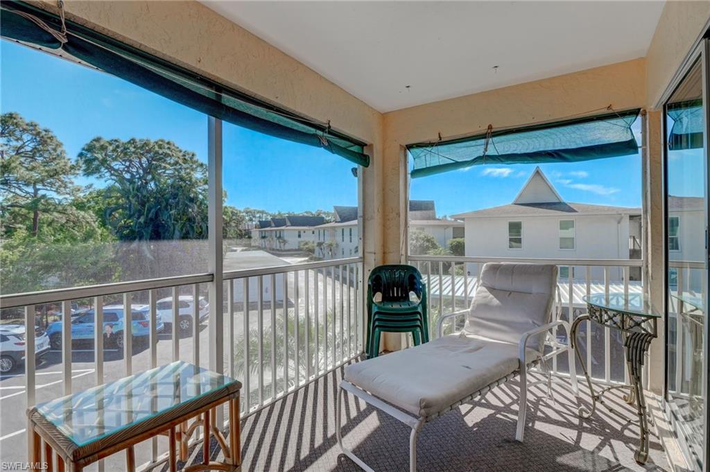115 Georgetown Boulevard, Unit 115 Naples, FL 34112 - Photo 23 of 45 a view of a balcony with furniture