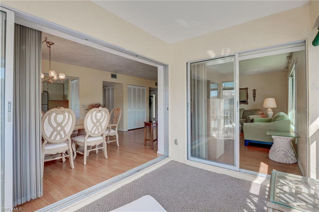 115 Georgetown Boulevard, Unit 115 Naples, FL 34112 - Photo 24 of 45 a dining room with furniture and a table