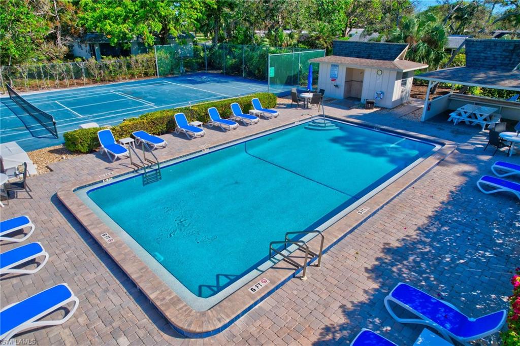 115 Georgetown Boulevard, Unit 115 Naples, FL 34112 - Photo 25 of 45 a view of a pool with chairs