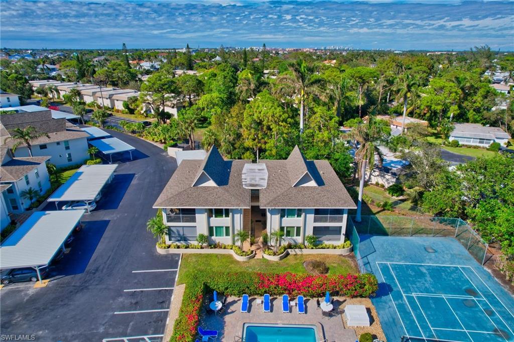 115 Georgetown Boulevard, Unit 115 Naples, FL 34112 - Photo 29 of 45 a front view of a house with garden