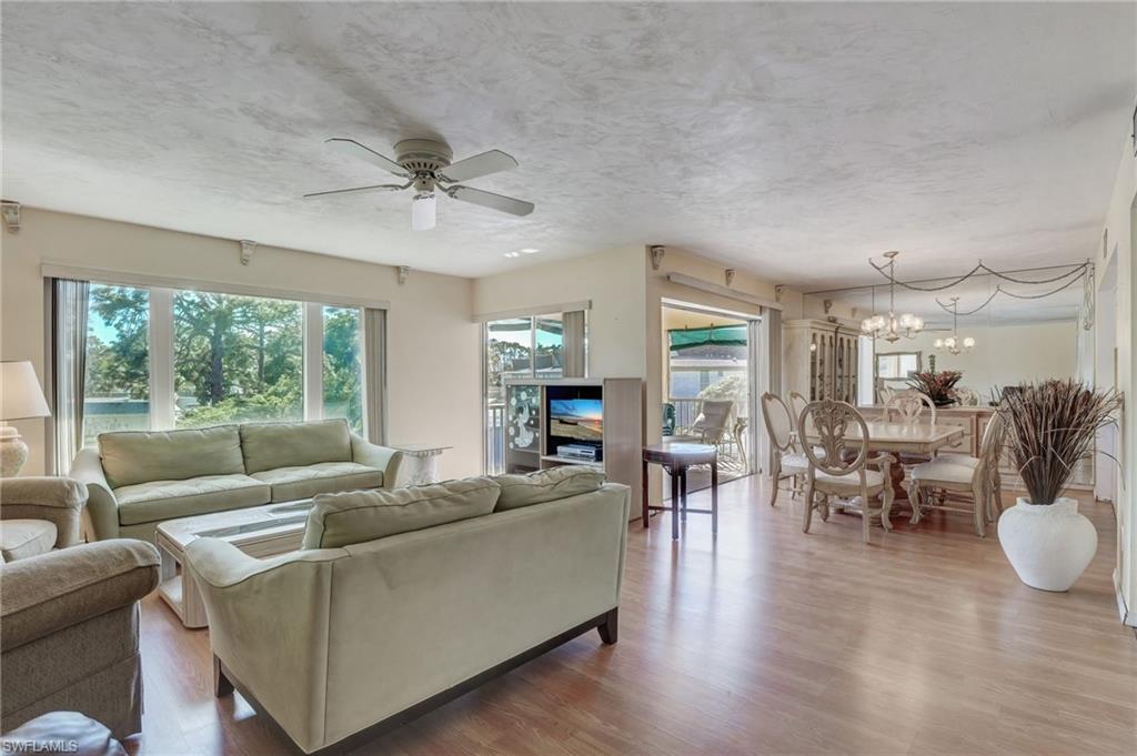 115 Georgetown Boulevard, Unit 115 Naples, FL 34112 - Photo 4 of 45 a living room with furniture and a large window