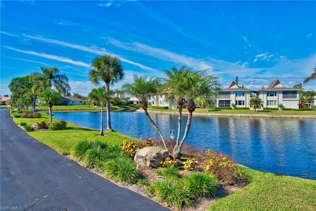 115 Georgetown Boulevard, Unit 115 Naples, FL 34112 - Photo 45 of 45 a view of a lake with a house in the background