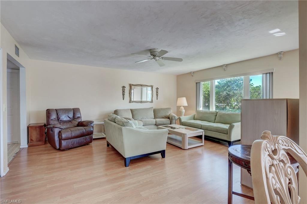 115 Georgetown Boulevard, Unit 115 Naples, FL 34112 - Photo 6 of 45 a living room with furniture and a window