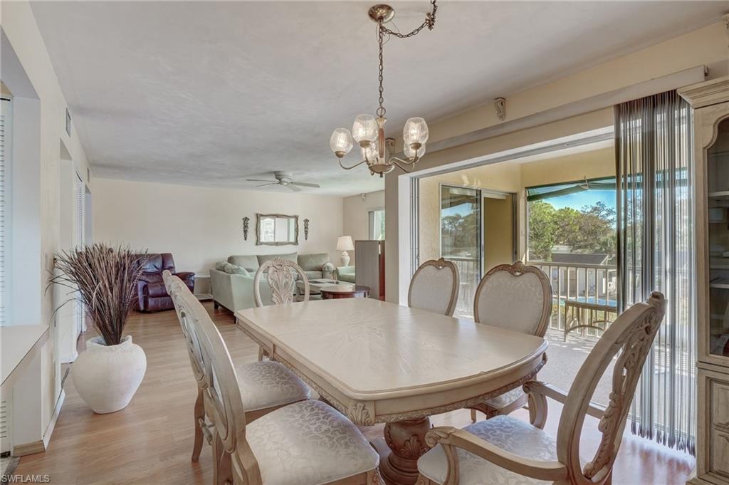 115 Georgetown Boulevard, Unit 115 Naples, FL 34112 - Photo 10 of 45 a view of a dining room with furniture window and outside view