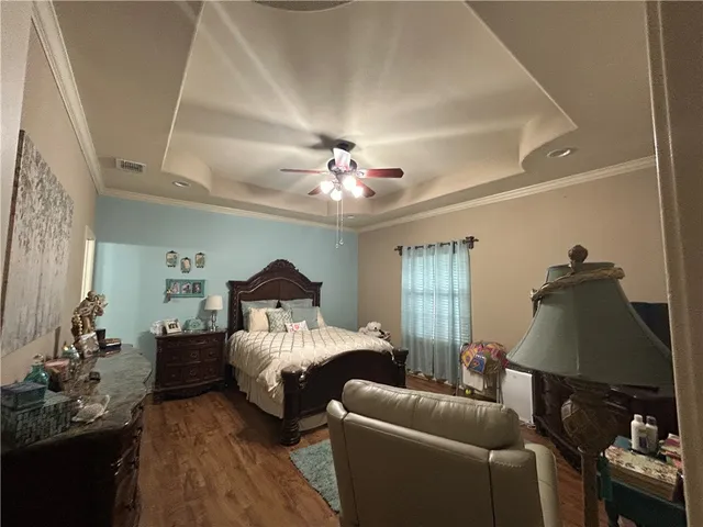 a bedroom with furniture and a chandelier