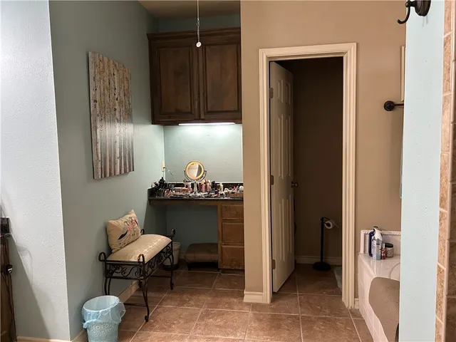 a view of bathroom with a table and a chair