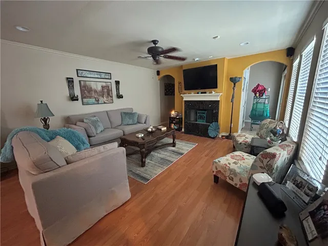 a living room with furniture a fireplace and a flat screen tv