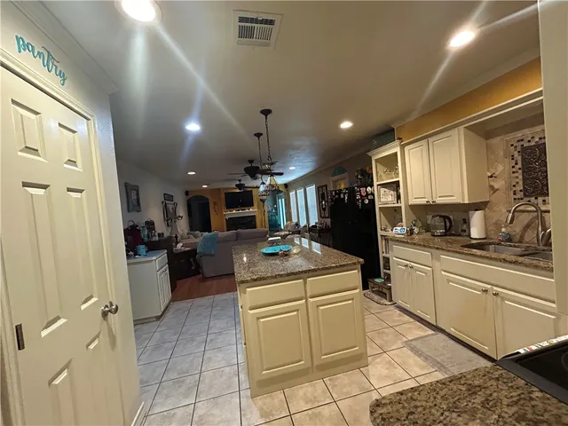 a kitchen with a sink appliances and cabinets