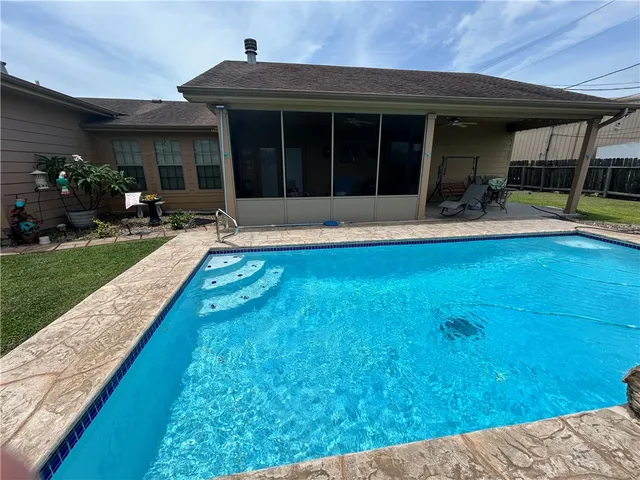 a view of a house with swimming pool and porch with furniture