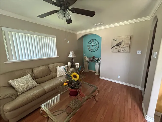 a living room with furniture and wooden floor