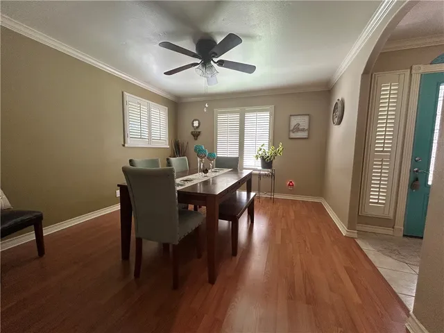 a view of a a dining room with furniture window and wooden floor