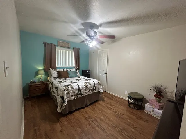 a bedroom with a bed and a potted plant