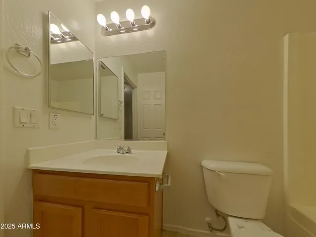 a white toilet sitting next to a bath tub