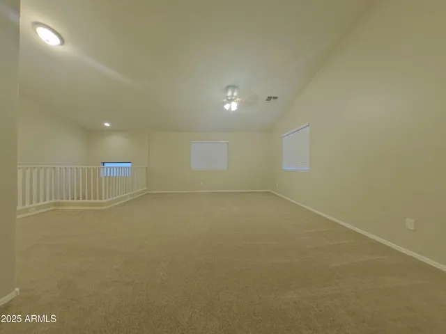an empty room with a empty space and windows