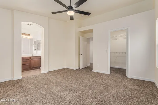 an empty room with a bathroom and a mirror