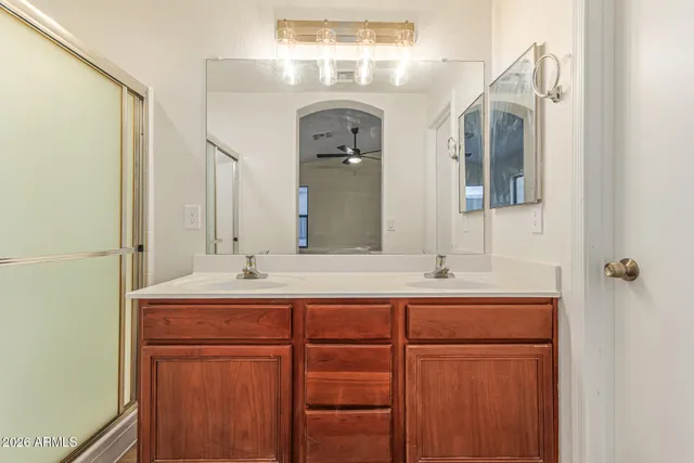 a bathroom with a double vanity sink and a mirror