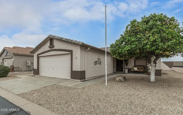 a view of a house with a yard and garage
