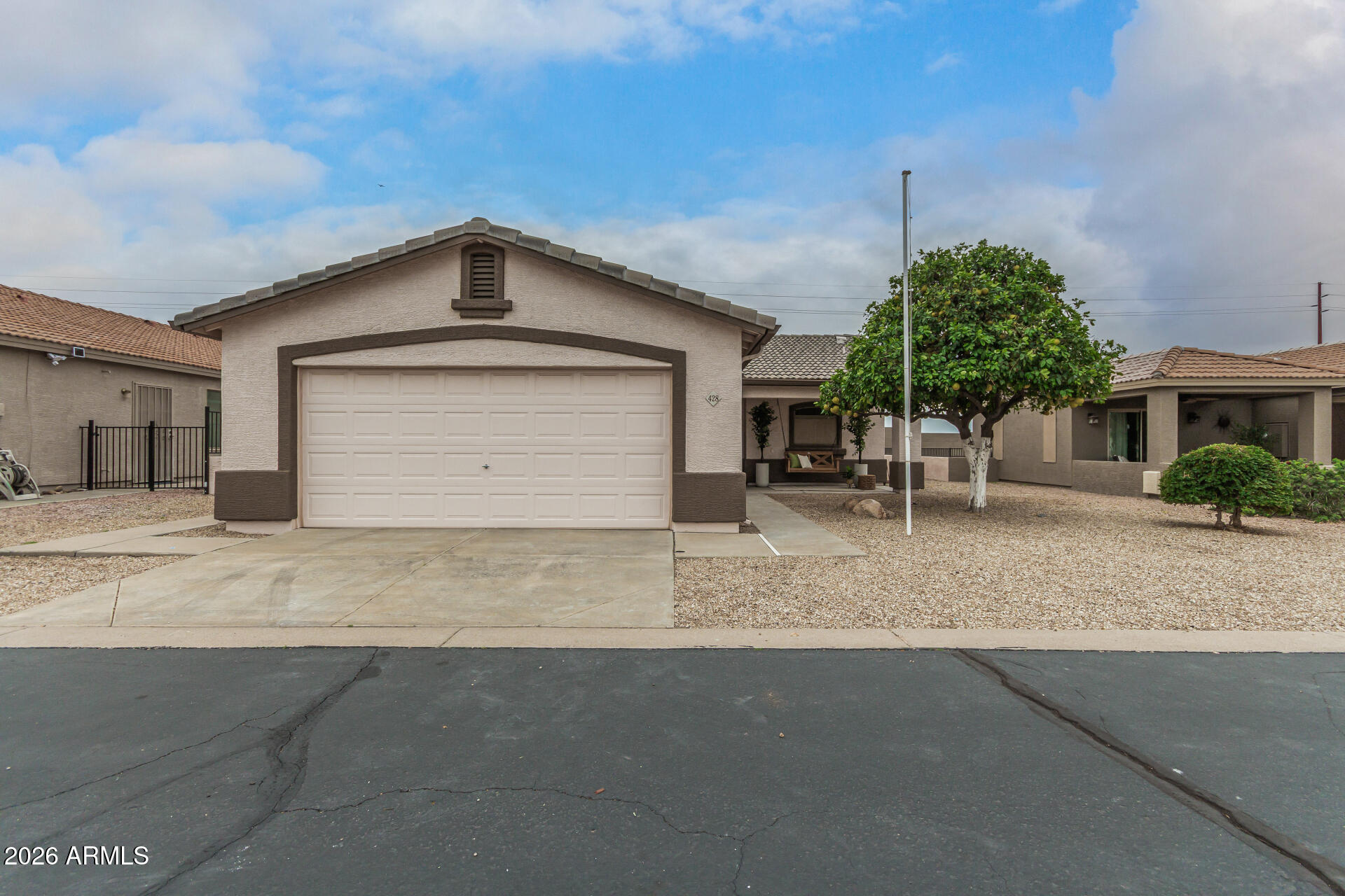 2101 South Meridian Road, Unit 428 Apache Junction, AZ 85120 - Photo 23 of 23 a front view of a house with a yard and garage