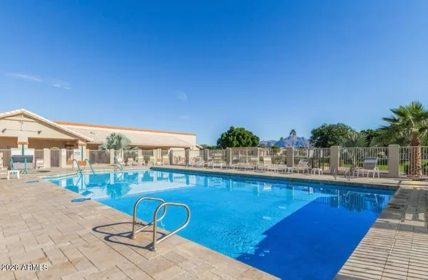 a view of a swimming pool with outdoor seating