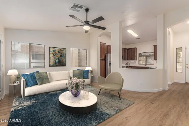 a living room with furniture and kitchen view