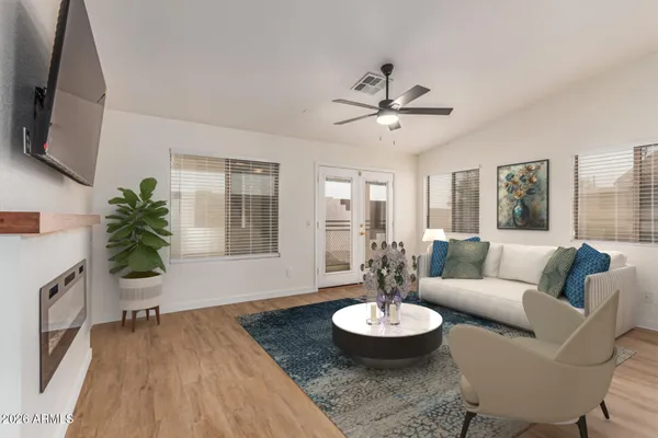 a living room with furniture and a wooden floor