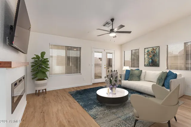 a living room with furniture and a wooden floor