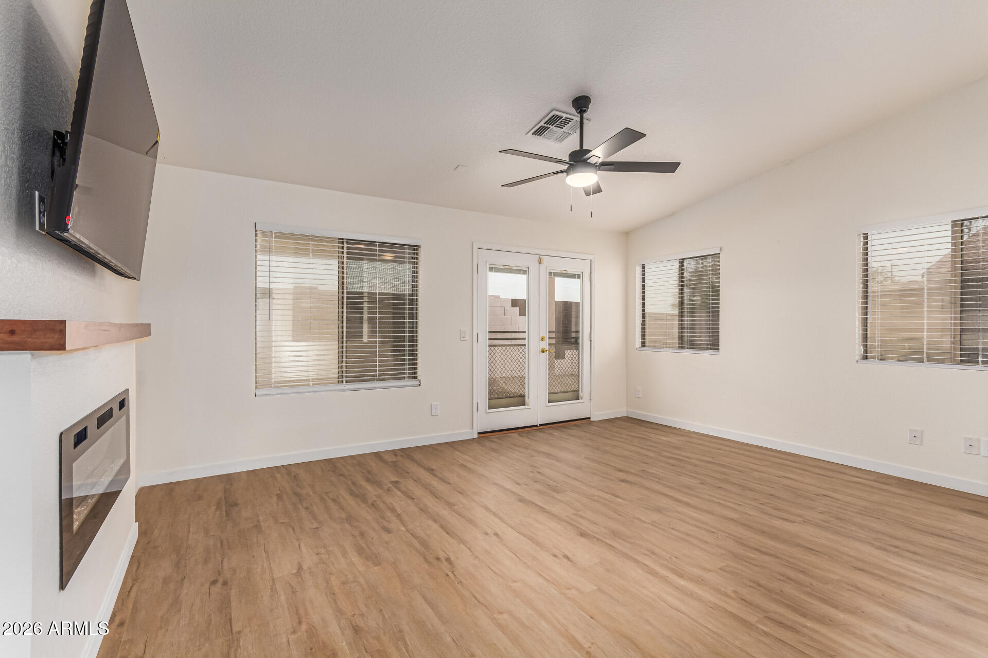 2101 South Meridian Road, Unit 428 Apache Junction, AZ 85120 - Photo 8 of 23 a view of an empty room with a window and wooden floor
